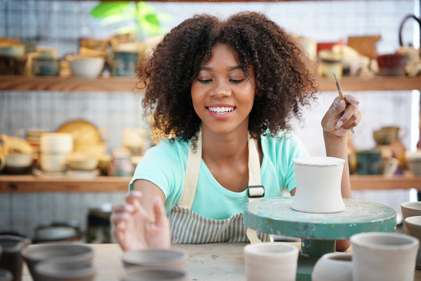 Young Afro girl in pottery workshop, Business owner - Photo, Image