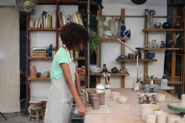 Ritratto di un ceramista creativo o imprenditore con prodotti ceramici presso il negozio di ceramiche - Foto, immagini