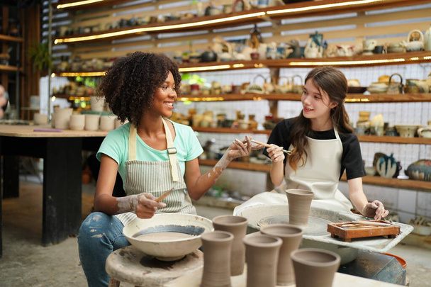Jeunes filles en atelier de poterie, Propriétaire d'entreprise.  - Photo, image
