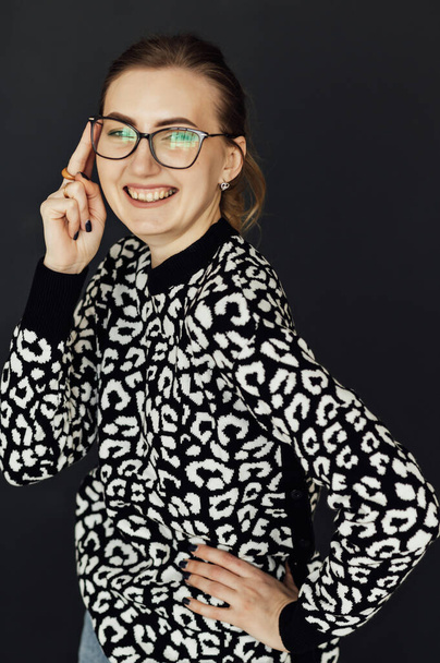 Beautiful girl in glasses looks at the camera and smiles. - Fotografie, Obrázek