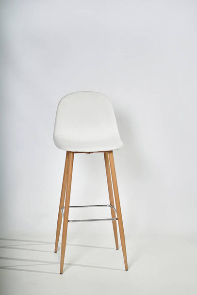                                Ein weißer Sessel mit Holzbeinen und einem Ledertop auf weißem Hintergrund. - Foto, Bild