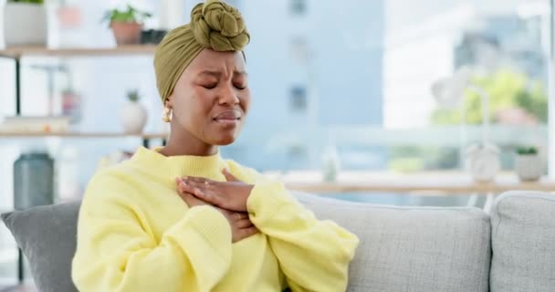 Black woman, cough and sick on sofa in home living room with chest pain, pneumonia or tuberculosis. Young, gen z African and coughing with lung infection, breathing problem or asthma on lounge couch. - Felvétel, videó