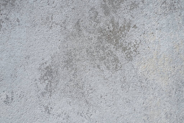 Plastered wall texture. Whitewash surface. Abstract background. Retro wall built structure texture. Cracks and bumps on the concrete wall. Uneven coloring with water-based paint. Old tattered plaster. - Foto, Bild