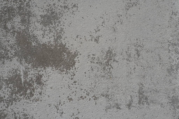 Plastered wall texture. Whitewash surface. Abstract background. Retro wall built structure texture. Cracks and bumps on the concrete wall. Uneven coloring with water-based paint. Old tattered plaster. - Foto, imagen