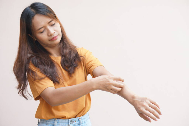 Asian woman having itchy skin on arm - Photo, Image