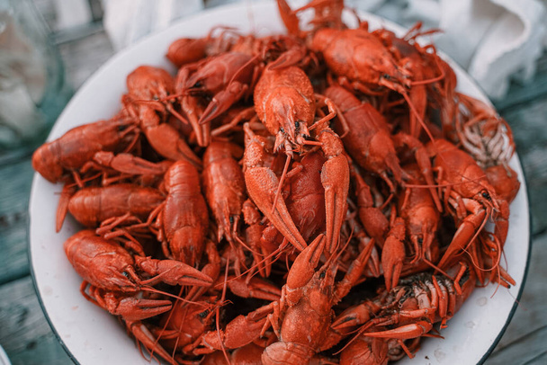 Rustic style large bowl with boiled crawfish, and on a grey-blue background. - Photo, Image