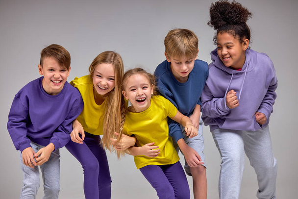 positive diverse children enjoys time together crazy kids laughing before start of running - Foto, Imagem