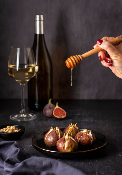 Food photography of  stuffed figs, goat cheese, riccotta, pine nuts, white wine - Фото, изображение