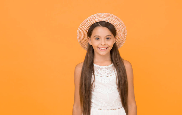 Summer vibes. joyful summer holiday and vacation. kid seasonal fashion. carefree beauty on yellow background. smiling kid in straw hat. little child ready for beach activity. happy childhood. - Foto, afbeelding