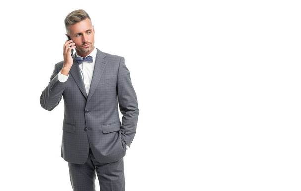 man in blue bow tie suit speak on phone isolated on white with copy space. - Foto, immagini