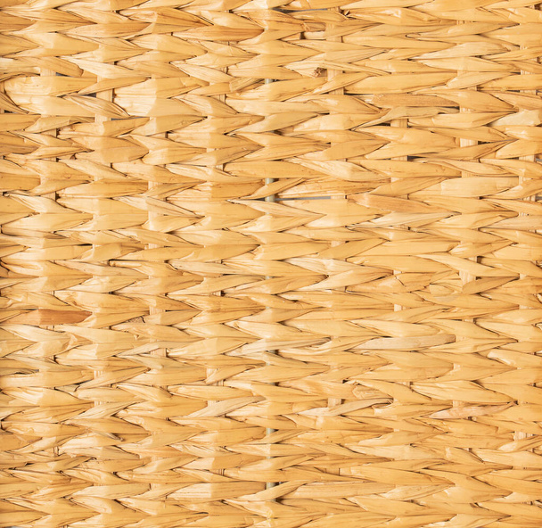 background of light yellow mat woven from reeds. - Foto, immagini