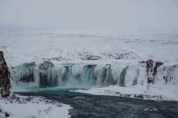 Godafoss waterfall in north Iceland on a snowy winter day - Фото, изображение