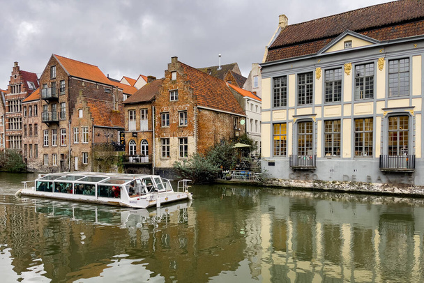 City tour boat sailing on the canal in Ghent, Belgium - 写真・画像