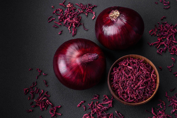 Fresh raw red onion on dark textured concrete background. Cooking at home - Foto, Bild