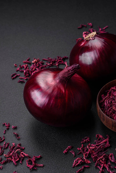 Fresh raw red onion on dark textured concrete background. Cooking at home - Fotografie, Obrázek