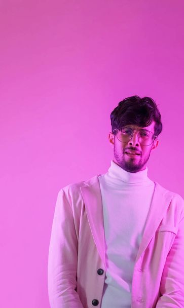 Overwhelmed face. Skeptic look. Question expression. Pink color neon light portrait of perplexed scared puzzled confused man on empty space background. - Fotografie, Obrázek