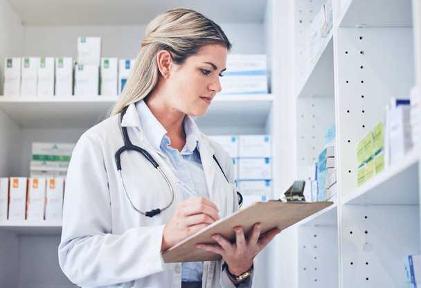 Inventory checklist, pharmacist and woman in pharmacy recording quantity of medication. Healthcare, wellness or female medical physician writing on clipboard, counting stock or medicine in drug store. - Fotoğraf, Görsel