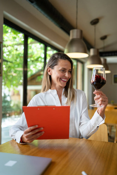 one woman mature adult caucasian female oenologist checking wine quality and compare the data for taste wine-making process concept real people small business female entrepreneur concept copy space - Photo, Image