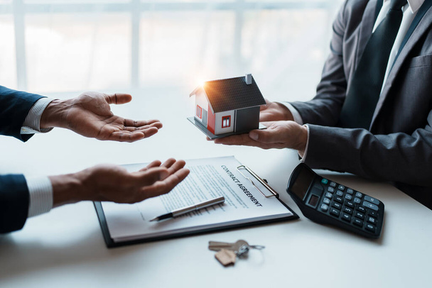 Real estate company to buy houses and land are delivering keys and houses to customers after agreeing to make a home purchase agreement and make a loan agreement - Foto, Imagem