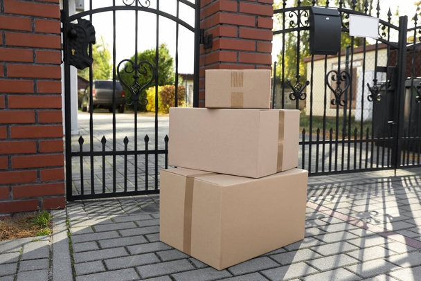 Stack of parcels delivered near front gates - Zdjęcie, obraz