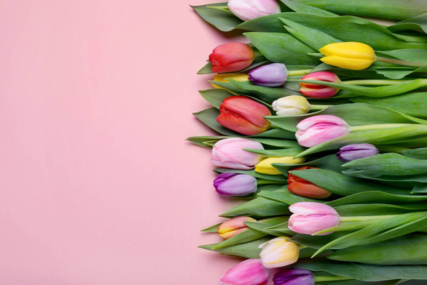 Beautiful tulips on pale pink background, flat lay. Space for text - Fotoğraf, Görsel