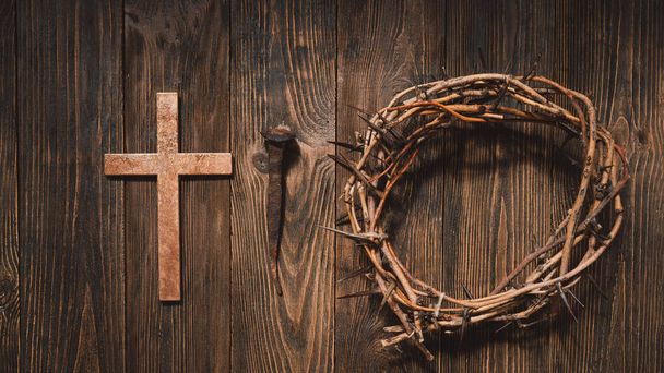 Jesus Crown Thorns and nails and cross on a wood background. Crucifixion Of Jesus Christ. Passion Of Jesus Christ. Concept for faith, spirituality and religion. Easter Day - Fotografie, Obrázek