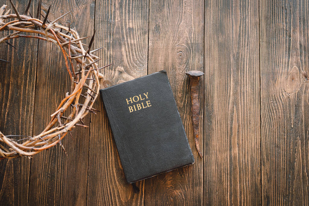 Crown thorns and holy bible or book on a wood background, copy space. Concept for faith, spirituality and religion - Fotografie, Obrázek