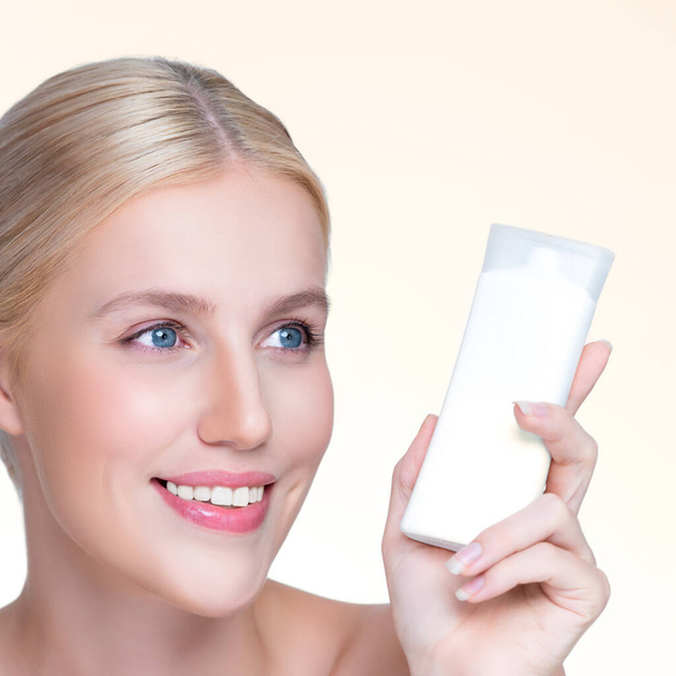 Closeup personable beautiful perfect natural skin woman hold mockup tube moisturizer cream for skincare treatment product advertising expressive facial and gesture expression in isolated background. - Photo, Image