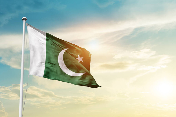 Pakistan waving flag in beautiful sky with sun - Zdjęcie, obraz