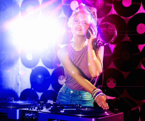 No one can beat her tunes. a hip young DJ holding her headset looking at the camera - Fotografie, Obrázek