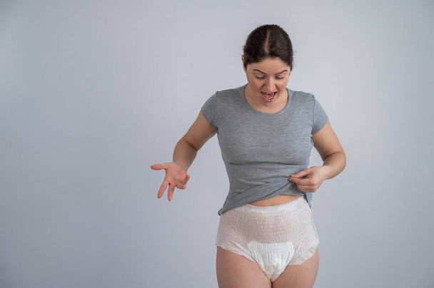 A woman in adult diapers. Urinary incontinence problem - Valokuva, kuva