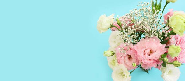 Top view image of delicate lisianthus flowers over pastel blue background - Fotoğraf, Görsel