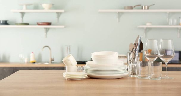 Set of clean dishes on kitchen table - Photo, Image