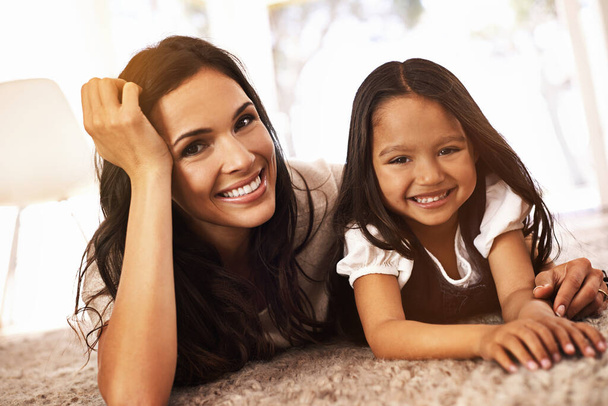 Like two peas in a pod. Cropped portrait of a happy mother and daughter at home - Foto, imagen