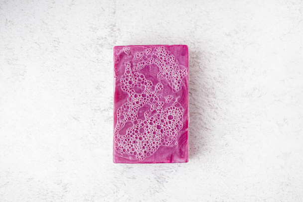 Natural soap bar with foam on light background - Photo, image