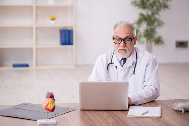 Old doctor in telemedicine concept - Photo, Image