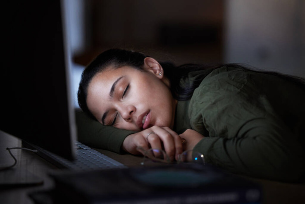 Tired, night and a business woman sleeping at her desk while working overtime in her office. Burnout, deadline and exhausted with a female employee asleep in the workplace during the late shift. - Photo, Image