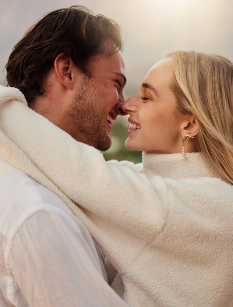 Love, smile and kiss with couple in nature for romance, bonding and affectionate together. Sensual, happiness and embrace with man and woman hugging on date for sunset, anniversary and summer break. - Valokuva, kuva