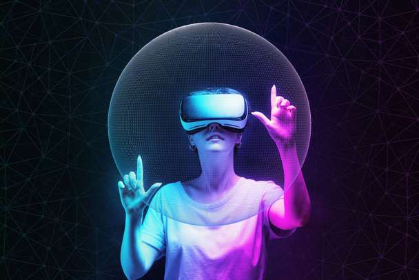 Meta evren ve 3 boyutlu simülasyon. VR gözlüklü genç bir kadının portresi ağ küresi yaratır. Neon soyutlamalı koyu bir arka plan. Sanal gerçeklik ve gelecekçilik kavramı. - Fotoğraf, Görsel