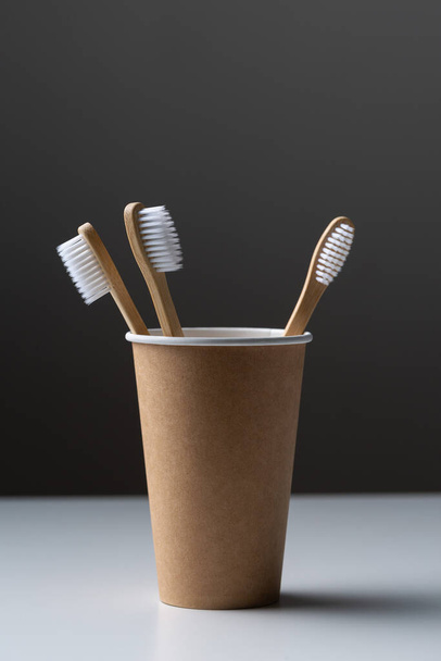 Toothbrush in a cardboard ecological cardboard cup, hygiene health care. - 写真・画像