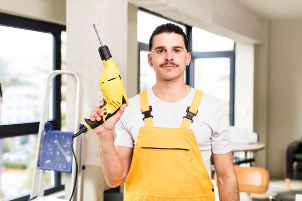 young handsome man handyman or housekeeper concept at home interior - Fotó, kép