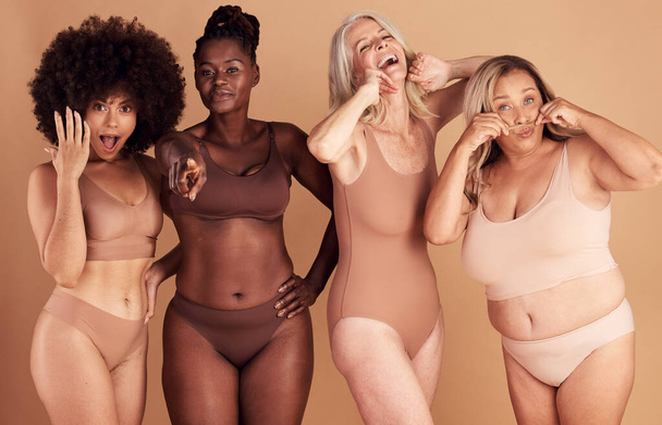 Women, body and beauty with diversity and underwear, body positivity and inclusivity, playful on studio background. Smile, portrait and fitness with skin and different shape and size, young and old - Foto, Imagen