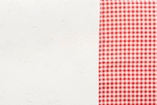 top view with red empty kitchen napkin isolated on table background. Folded cloth for mockup with copy space, Flat lay. Minimal style. - Фото, зображення