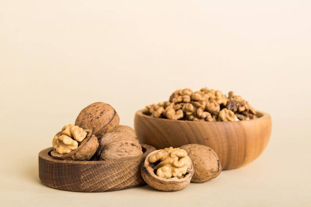 Fresh healthy walnuts in bowl on colored table background. Top view Healthy eating bertholletia concept. Super foods. - Photo, image