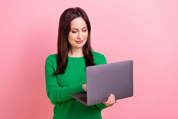 Photo of cute busy woman wear green sweater typing emails twitter telegram facebook emtpy space isolated pink color background. - Foto, afbeelding