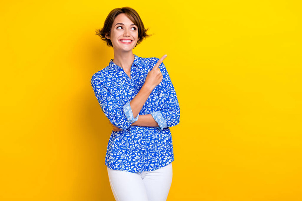 Photo of dreamy charming lady wear print shirt looking showing finger empty space isolated yellow color background. - Φωτογραφία, εικόνα