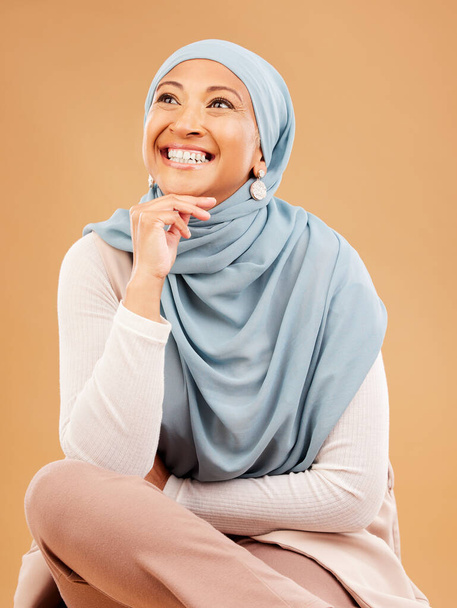 Muslim, fashion and woman in studio thinking of hijab beauty, makeup ideas and cosmetics with mockup and smile. Happy islamic model with designer fabric, silk and inspiration for Arab culture. - Foto, Imagen