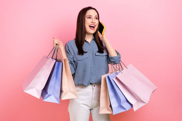 Photo of excited positive lovely lady wear trendy clothes speaking telephone courier delivery service isolated on pink color background. - Фото, зображення