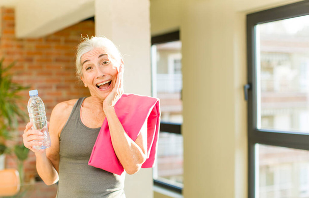 senior pretty woman feeling happy and astonished at something unbelievable. fitness concept - Fotoğraf, Görsel