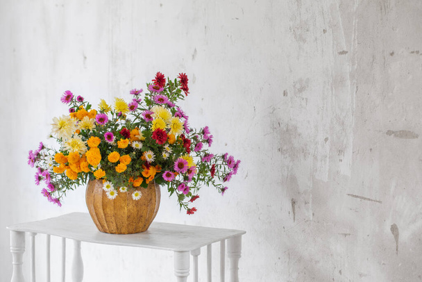 bouquet of colorful chrysanthemums in vase on background white old wall - Fotografie, Obrázek
